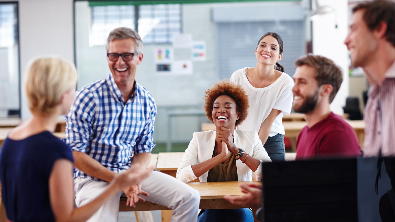 Engaging and fun health and safety training a group of employees laughing at a workplace workshop