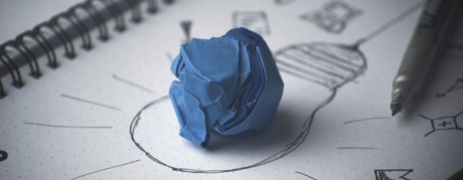 A sketch of a lightbulb with a crumpled blue piece of paper in the middle of the drawing