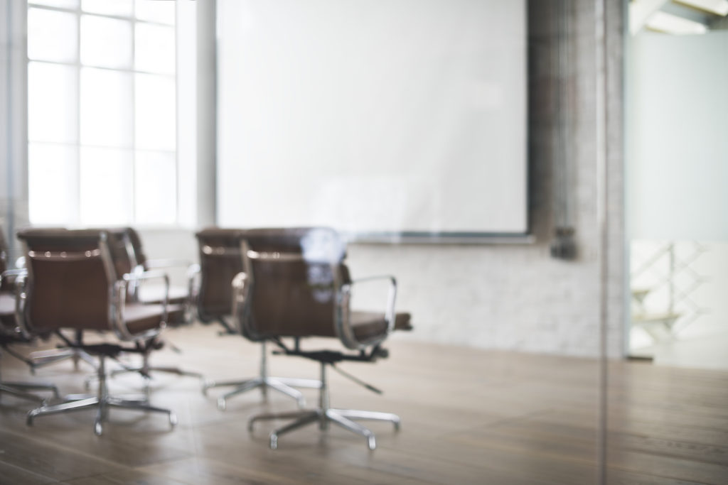 A group of chairs sitting in front of a projector screen