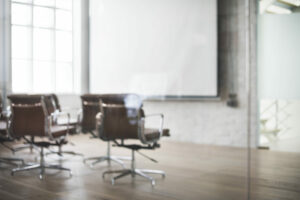 A group of chairs sitting in front of a projector screen