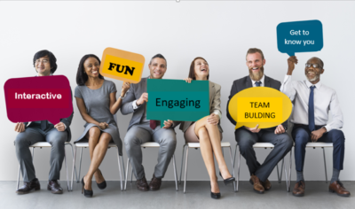 A group of people sitting in a row holding colourful shapes that read "Interactive, Fun, Engaging, Team Building, Get to Know You