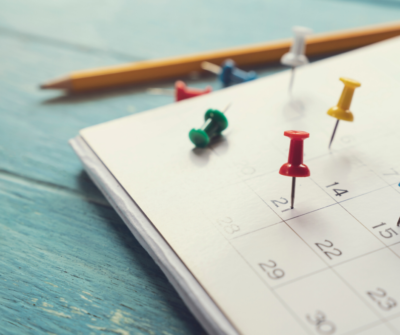 calendar with thumb tacks in it