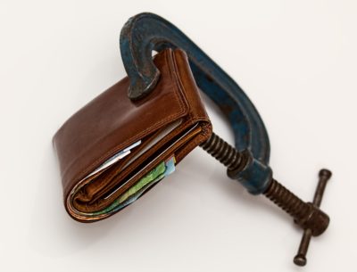 A wallet with a c-clamp holding it closed