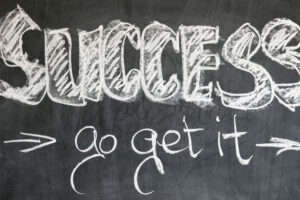 A chalkboard with the word "success" and "go get it" written on it