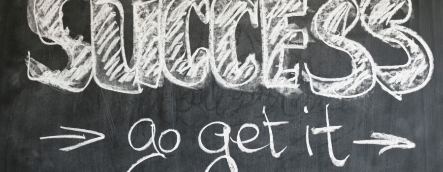 A chalkboard with the word "success" and "go get it" written on it
