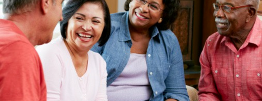 A group of people sitting together, smiling and laughing