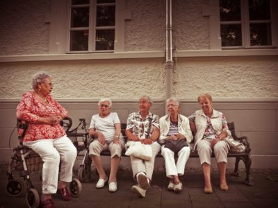 A group of elderly women sitting on a bench