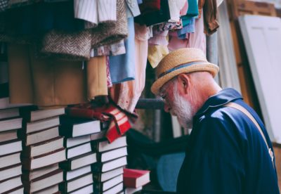 A man looking at a stack of books