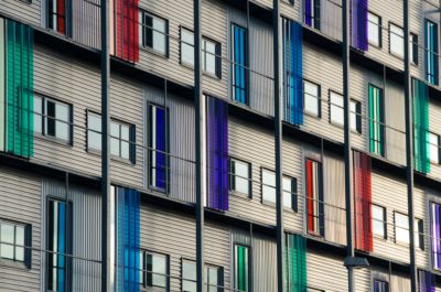 Apartment building, with different colours on it, and windows. Representing a variety of learners.