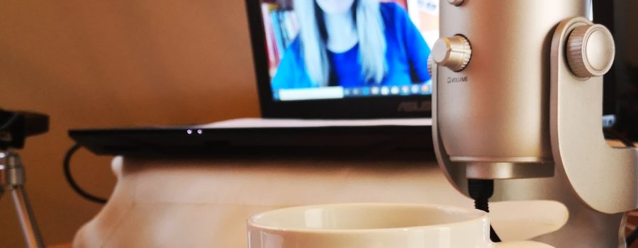 patricia shown on computer screen, showing her desk, mic, mug and set up for an online workshop