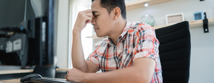 man disappointed when looking at computer screen