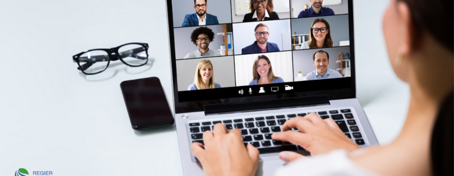 woman typing on laptop with 9 people on video conference who may have Zoom Fatigue