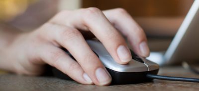 A persons hand on computer mouse