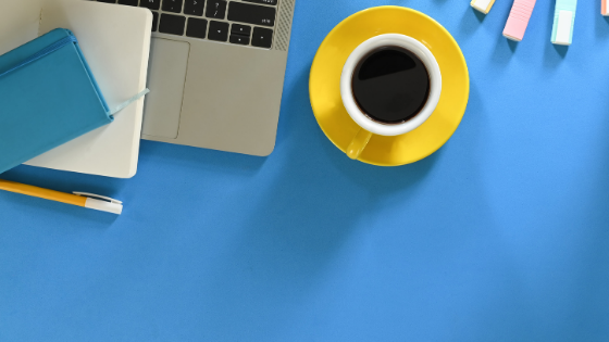 blue desk top, laptop, yellow coffee cup