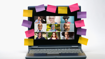 opening large online meetings with laptop with 9 people on screen that is surrounded by post it notes in different colours