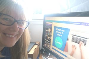 Patricia at her desk, in front of her computer smiling