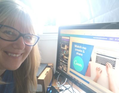 Patricia at her desk, in front of her computer smiling