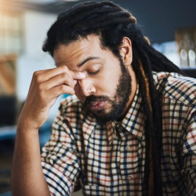 man holding bridge of nose, because computer just crashed