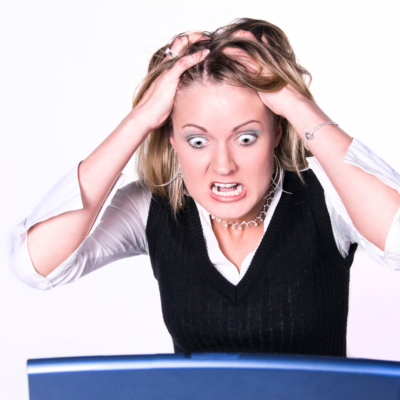 computer crashed woman pulling hair and upset look on her face