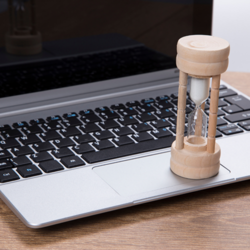 laptop and sand timer