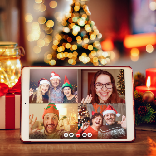 image of people celebrating online together with a Christmas tree in the background for a hybrid holiday party
