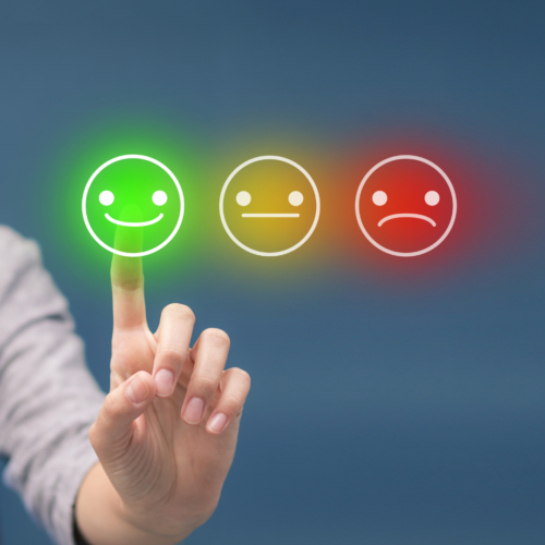 image of a person pointing to a happy face, straight face or frown face for evaluations