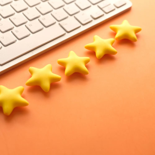 image of 5 stars on a desk in front of a keyboard for evaluations