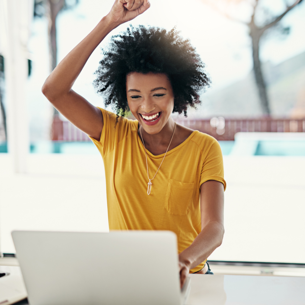 image of woman with laptop happy about new Zoom Breakout Rooms Feature