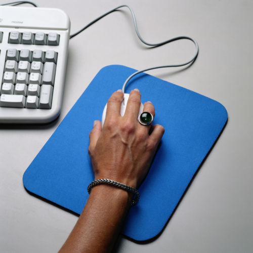 hand on computer mouse, blue mouse pad, and keyboard showing, setting up new Zoom feature