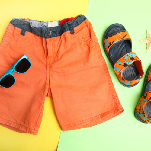 orange shorts for a hot summer with sandals and glasses