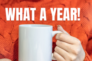 looking back blog image of a woman in an orange sweather holding a white mug, words what a year