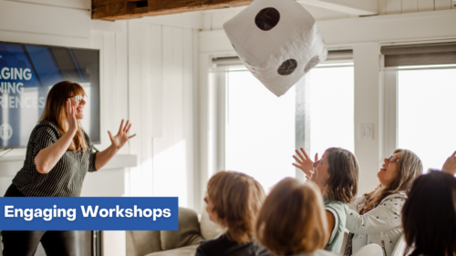 Patricia throwing a large dice to the workshop participants.