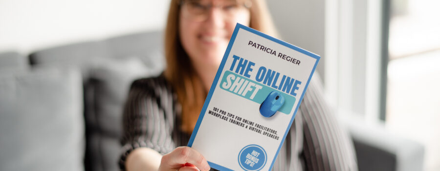 Patricia in background with a black and white stripped shirt, holding her book The Online Shift in the foreground.