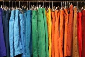 A variety of colourful shorts handing on hangers on a rack. Representing variety of options in everything that is figureoutable.