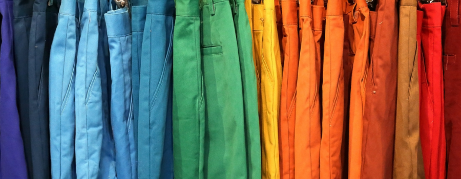 A variety of colourful shorts handing on hangers on a rack. Representing variety of options in everything that is figureoutable.