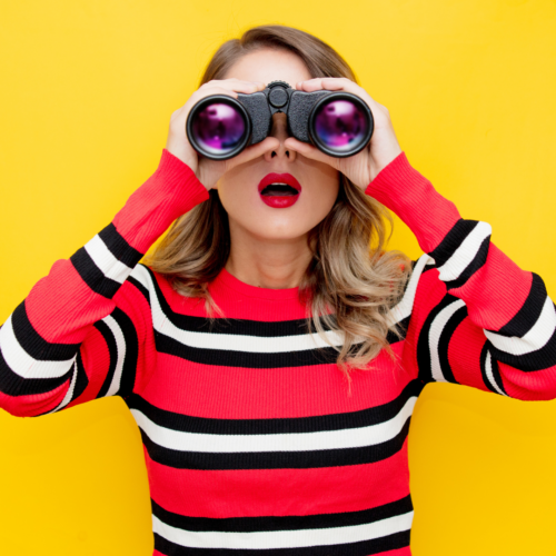 Person looking through binoculars. Most Watched Popular topics of 2023
