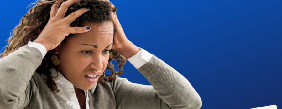 Woman hands on head looking concerned at the laptop. How to delete chat in Zoom.