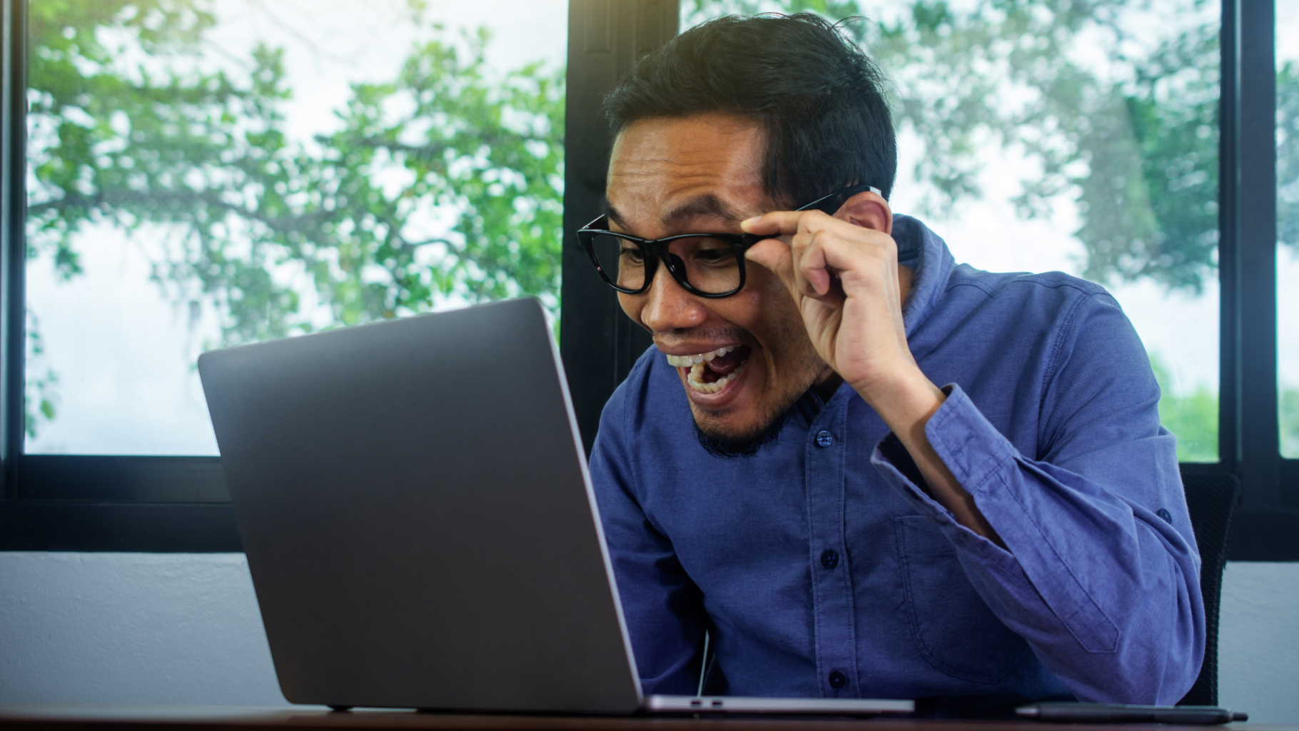 Person looking at a laptop excited and the AI discovery.