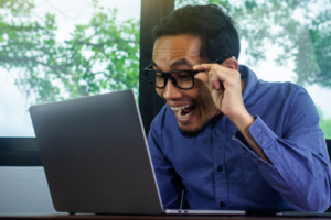 Person looking at a laptop excited and the AI discovery.